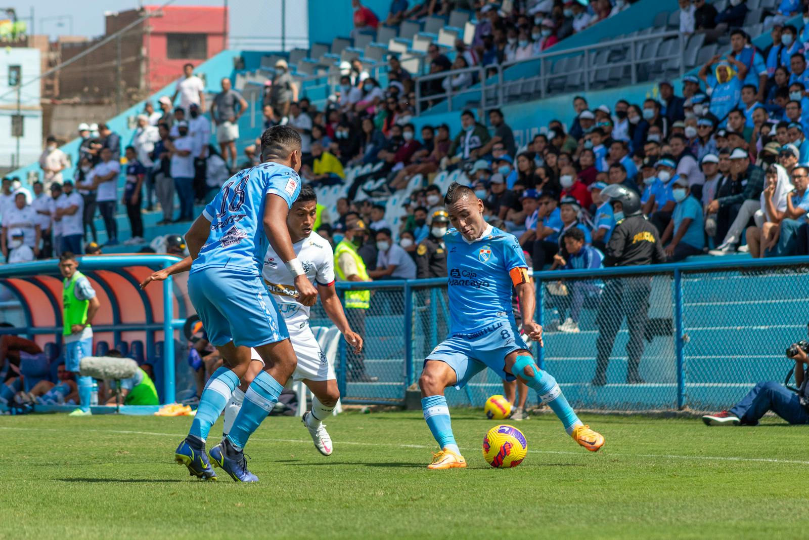 Dynamic soccer match with players in action, vibrant stadium atmosphere.